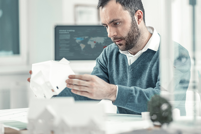 A person examining a product prototype